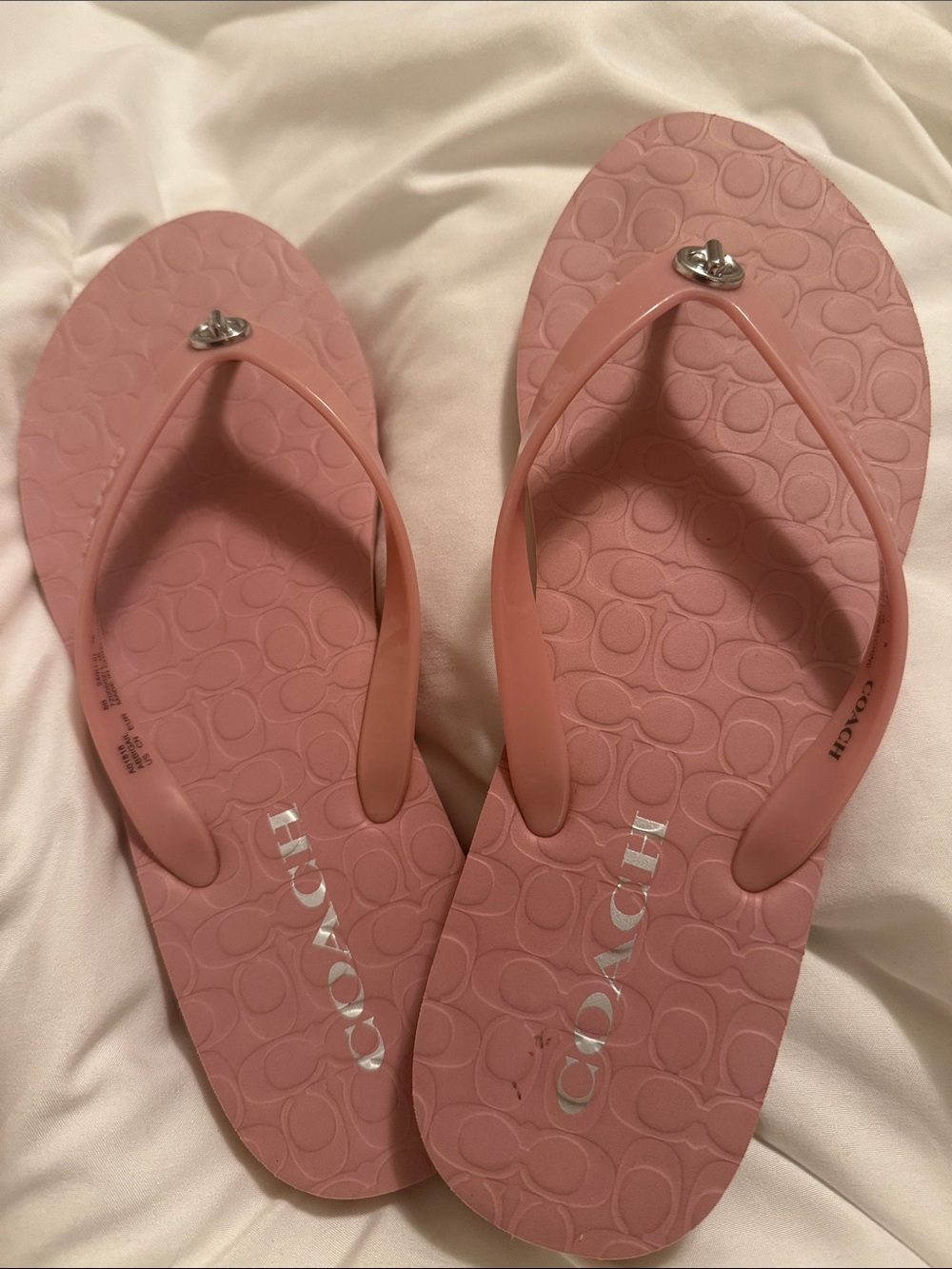 Pink Coach flip flops.
